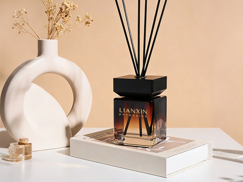 square amber gradient reed diffuser bottle with black flat cap and black reeds