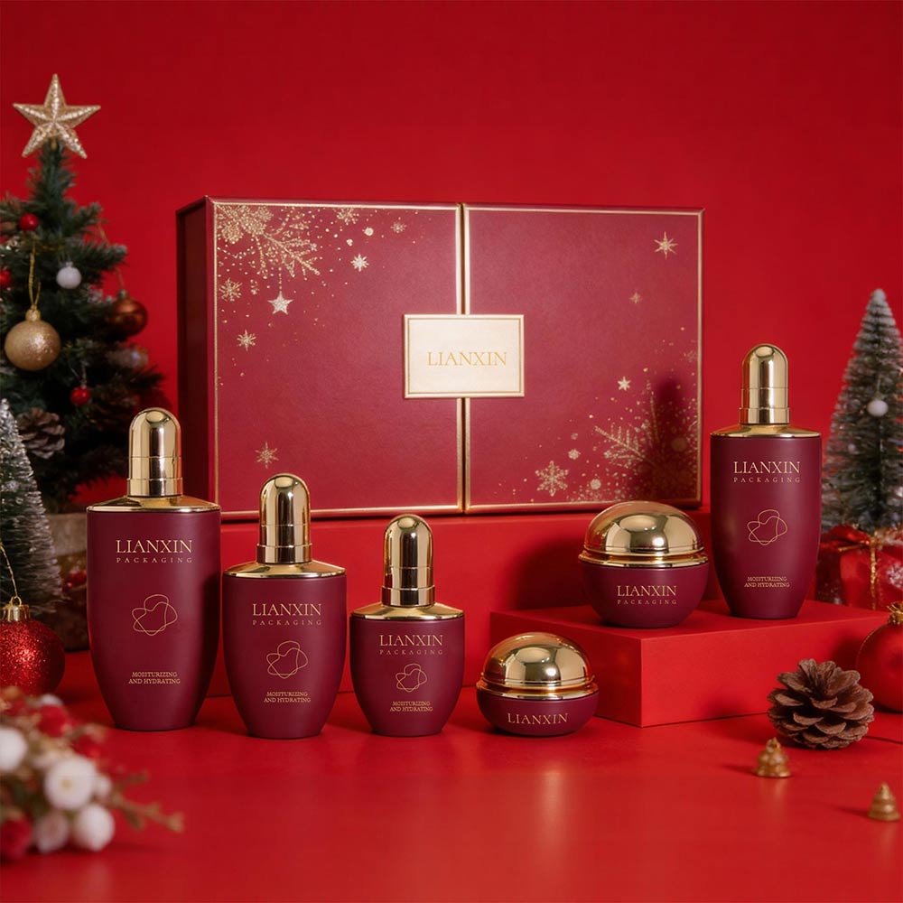 Luxury burgundy red glass cosmetic packaging set with gold caps and matching cream jars