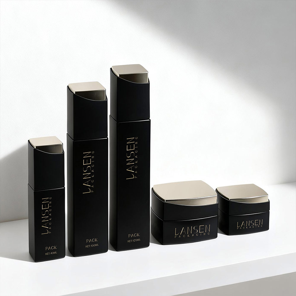 Premium black and gold skincare glass bottles and cream jars for luxury cosmetic packaging