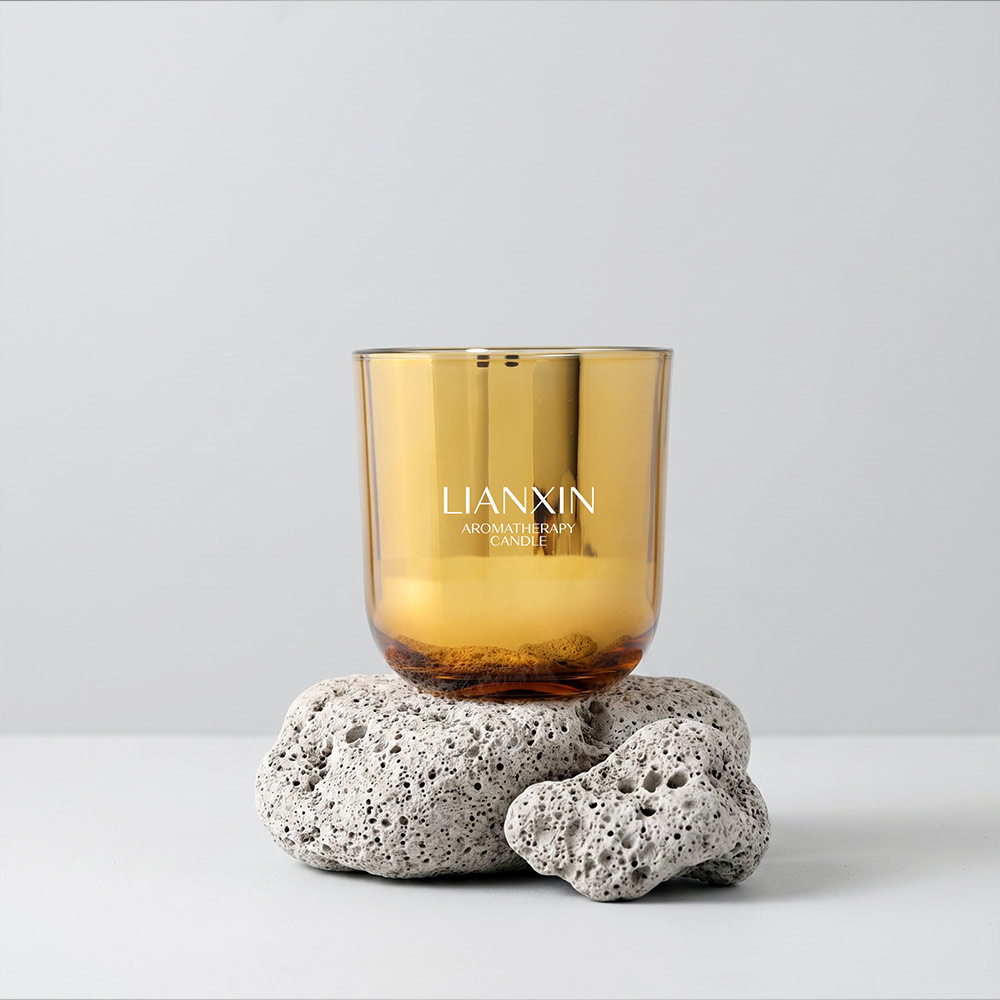 Gold 390ml Glass Candle Jar with Custom Gift Box 1 390ml amber gold glass candle jar displayed on lava stones