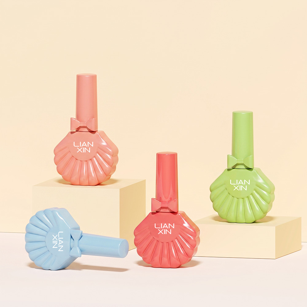 18ml Shell Shaped Glass Nail Polish Bottle with Brush Cap 3 18ml shell shaped glass nail polish bottles in coral, green and blue showing front and side views