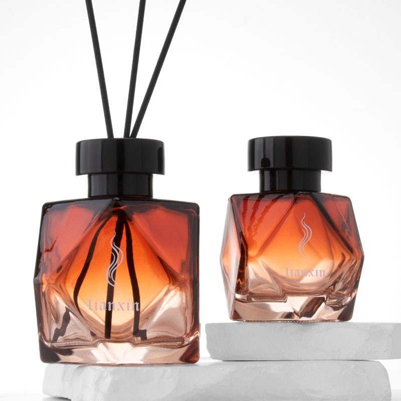100ml and 200ml irregular faceted amber glass reed diffuser bottles with glossy black caps