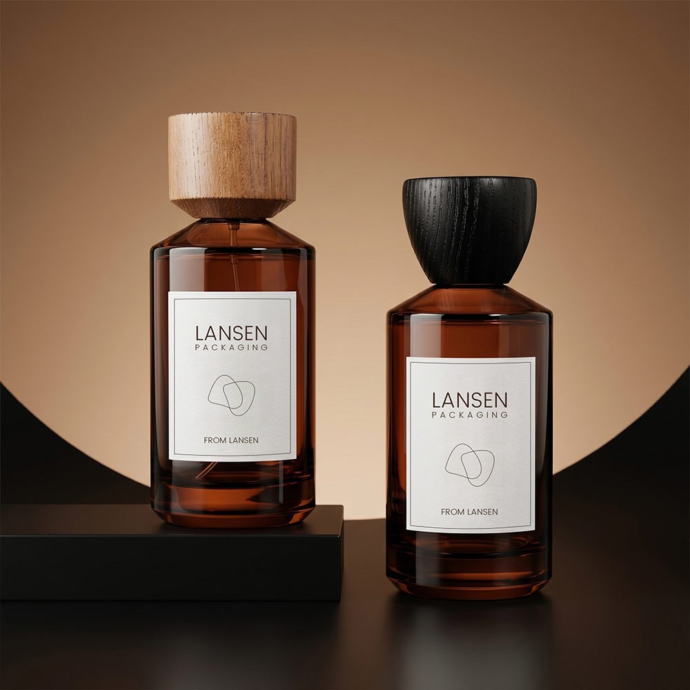 two 100ml amber cylinder glass perfume bottles, one with a light walnut cap and one with a black wood cap