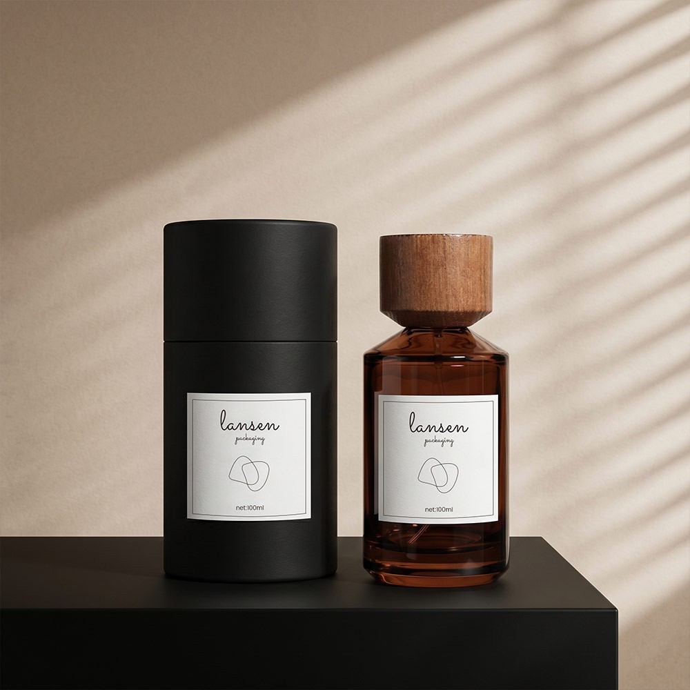 100ml amber cylinder glass perfume bottle with a wooden cap standing beside its matte black cylinder box
