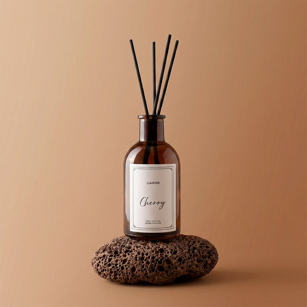 100ml Amber Glass Round Shoulder Reed Diffuser Bottle 1 100ml amber glass round shoulder reed diffuser bottle with black reeds and cherry scent label