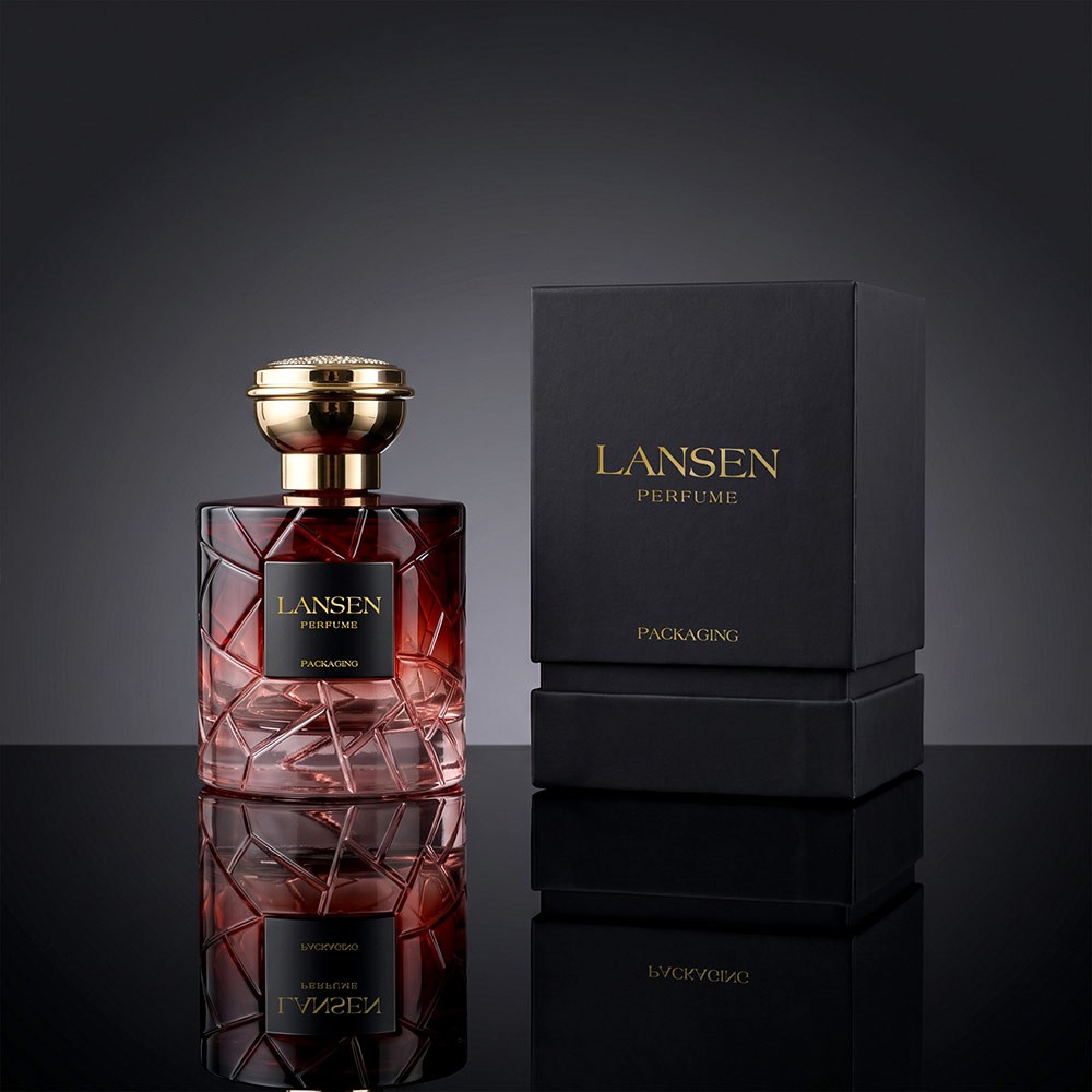 100ml crystal cut glass perfume bottle in deep red with a gold plated cap beside a black gift box