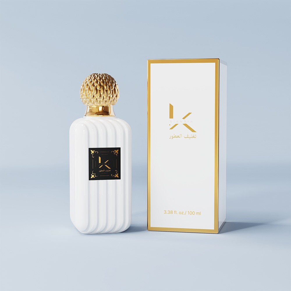 100ml ribbed rectangular glass perfume bottle in opaque white with a gold fluted cap beside its gold-trimmed 100ml gift box