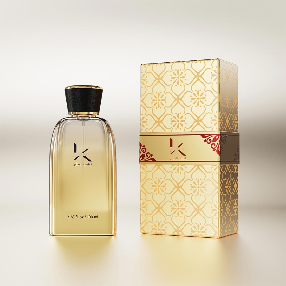 100ml sloped shoulder rectangular glass perfume bottle in clear amber glass with a black leather covered cap beside a gold patterned gift box