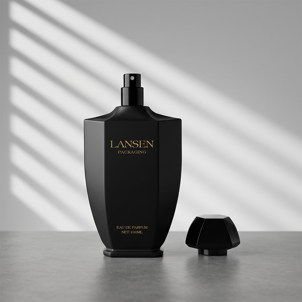 100ml tapered perfume bottle with the sprayer exposed and the faceted plastic cap standing separately beside it