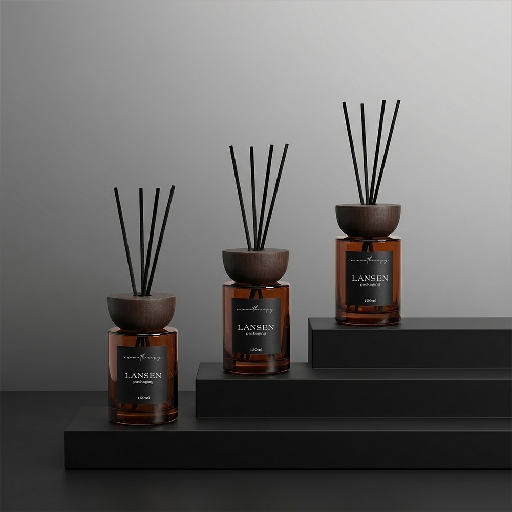 three 150ml amber cylindrical glass reed diffuser bottles with wooden caps and black labels