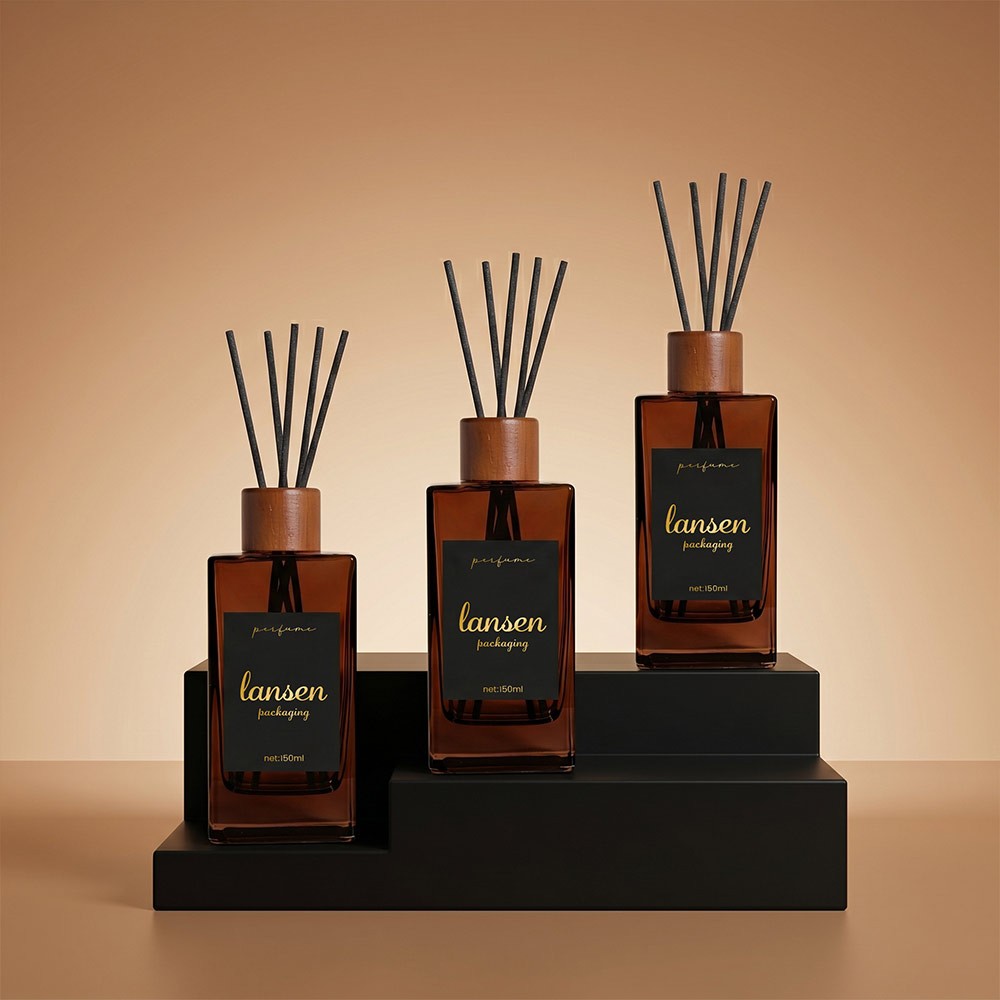 three 150ml amber rectangular glass reed diffuser bottles with wooden caps and printed labels