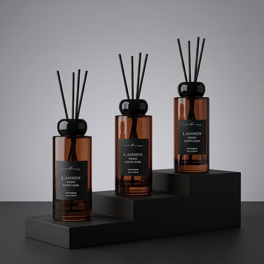 200ml cylindrical amber glass reed diffuser bottles displayed on black display steps