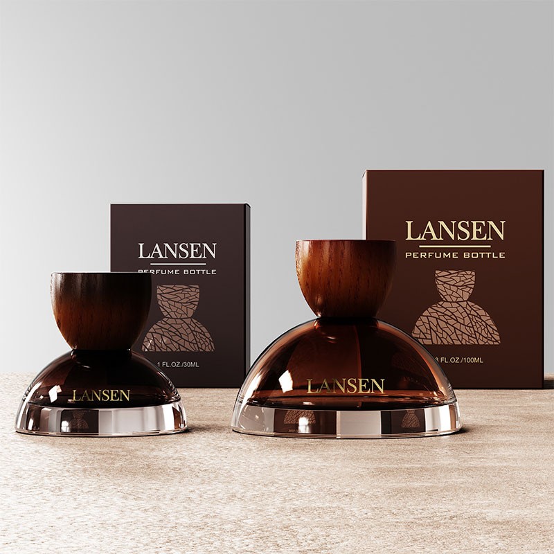 30ml and 100ml dome shaped perfume bottles with wood grain caps displayed beside their matching brown gift boxes