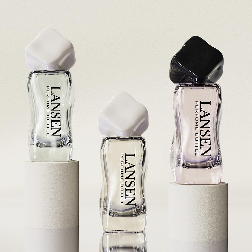three 30ml wavy shaped perfume bottles with white and black twisted caps shown in a clear glass colour range