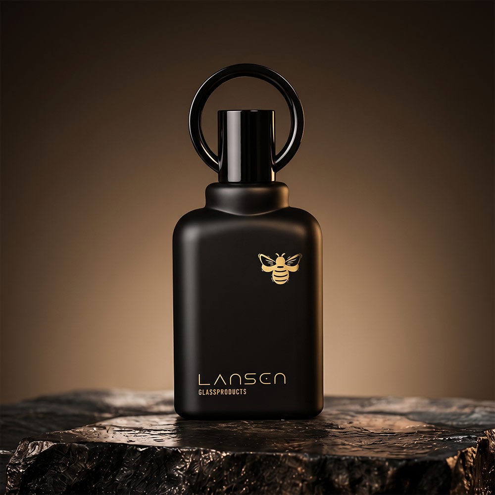 50ml matte black glass perfume bottle with a black ring cap standing on a dark stone slab
