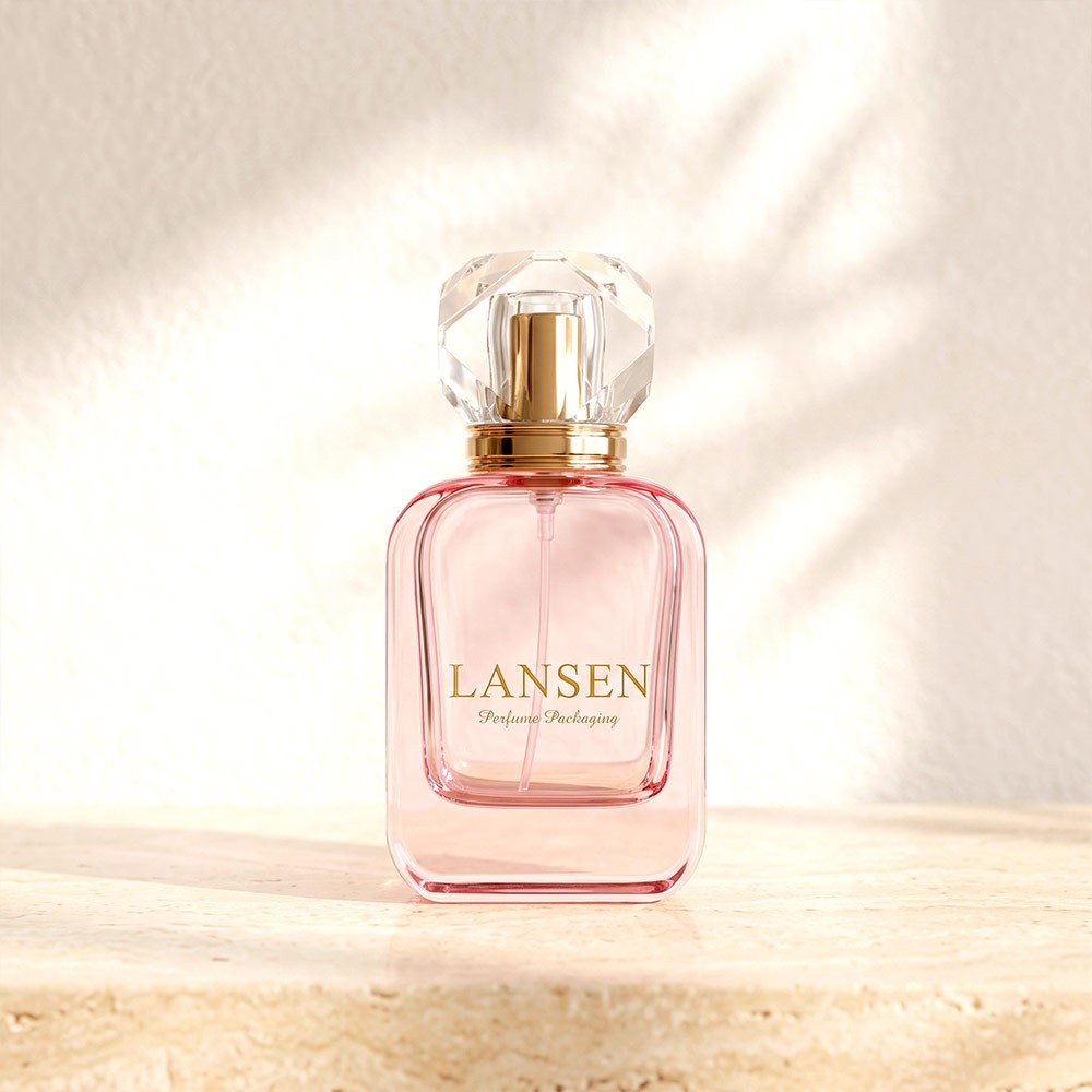 50ml pink flat square glass perfume bottle with a clear faceted acrylic cap standing on a stone ledge