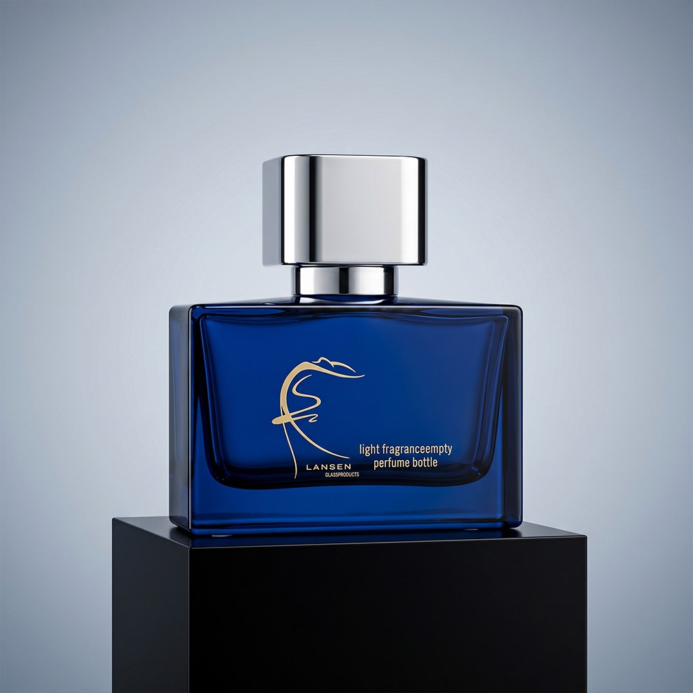 50ml navy blue cologne bottle with a polished mirror silver cap photographed on a dark plinth