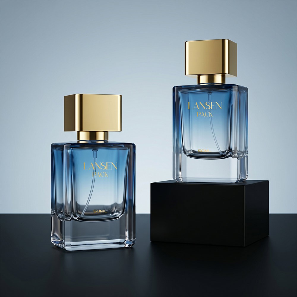two 50ml rectangular blue cologne bottles with gold plated square caps, one standing on a black plinth