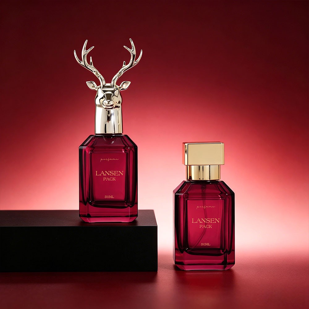two 50ml rectangular perfume bottles shown side by side, one with a gold stag head cap and one with a flat gold square cap