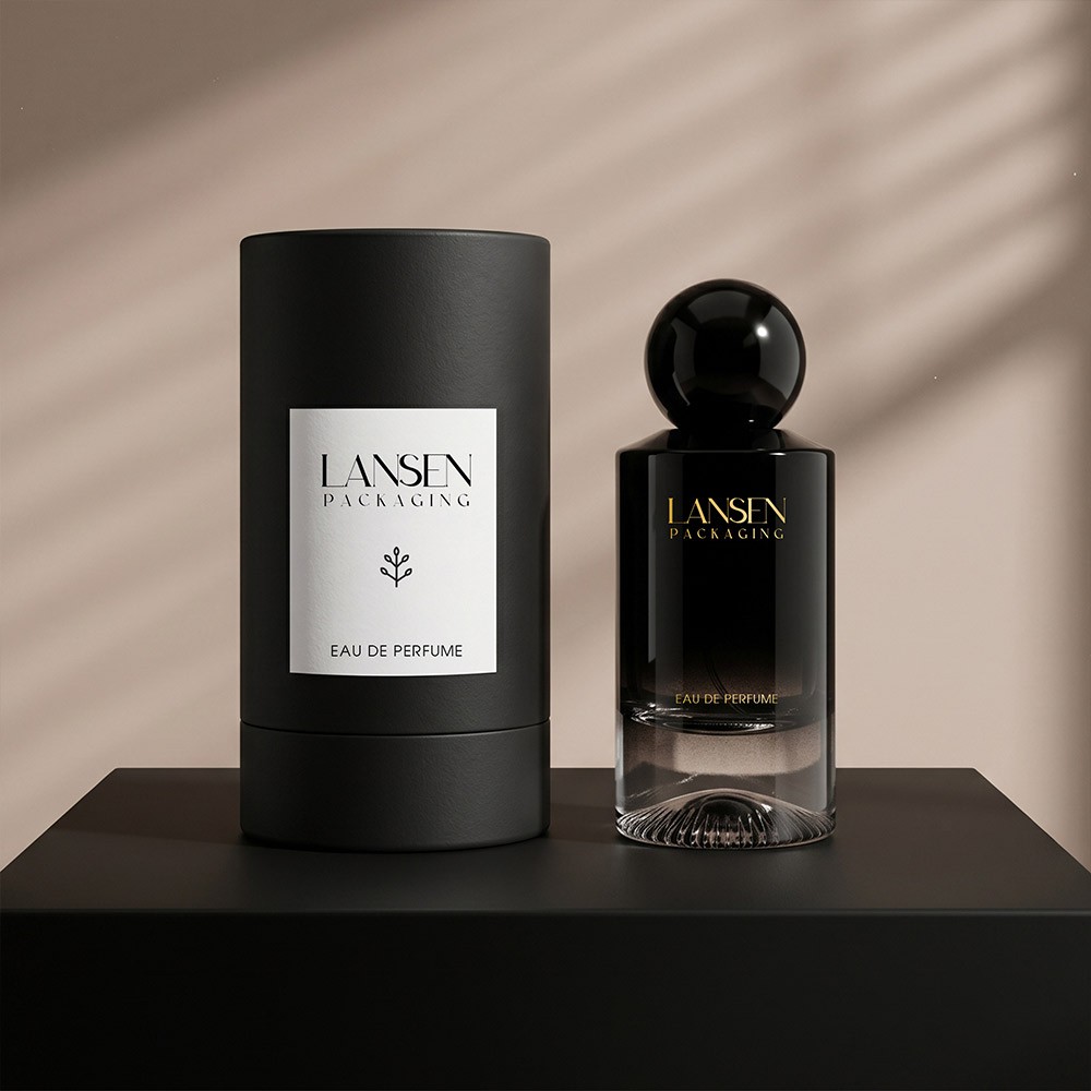 55ml black gradient glass perfume bottle with a high gloss spherical cap standing beside its matte black cylindrical tube box