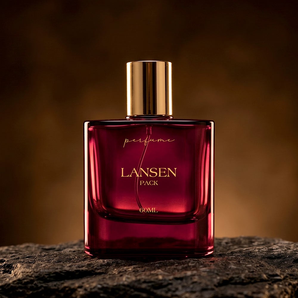 60ml rounded corner red perfume bottle with a plain gold cylindrical cap standing on a dark rock surface