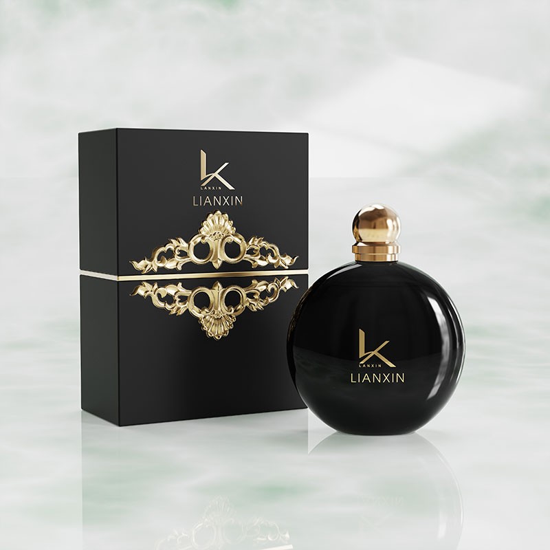 black round perfume bottle with gold ball cap and matching gold ornament gift box
