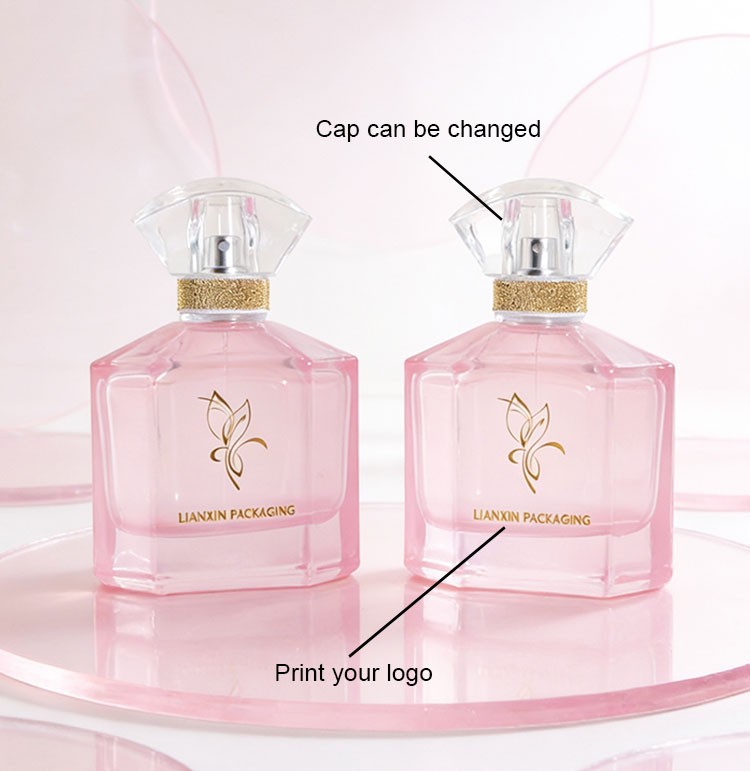 two custom chamfered corner perfume bottles showing a changeable clear fan cap and a printed brand logo