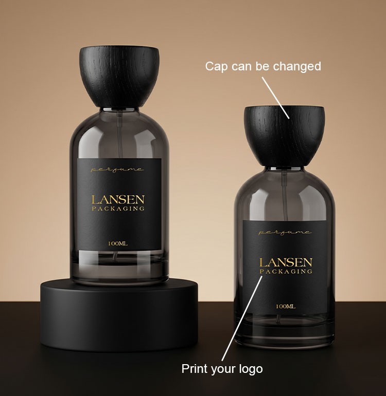 two custom grey glass perfume bottles showing a changeable flared wooden cap and a printed brand logo on the body label