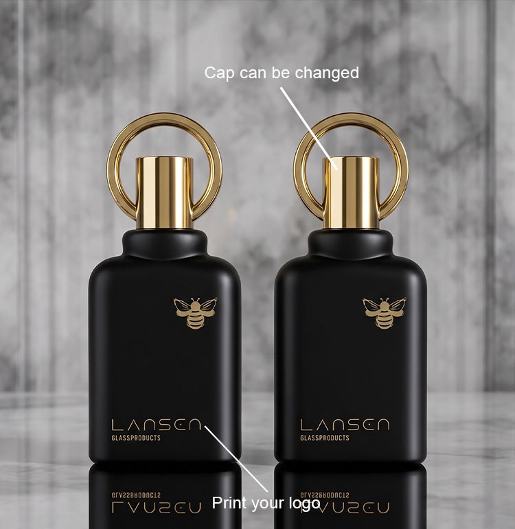 Screen Printing on Cosmetic Bottles: Cost, MOQ & Artwork Rules 2 screen printed gold logo and wordmark on matte black glass perfume bottles