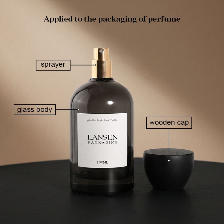 perfume bottle pump structure showing the gold sprayer, glass body and wooden cap on a grey glass perfume bottle