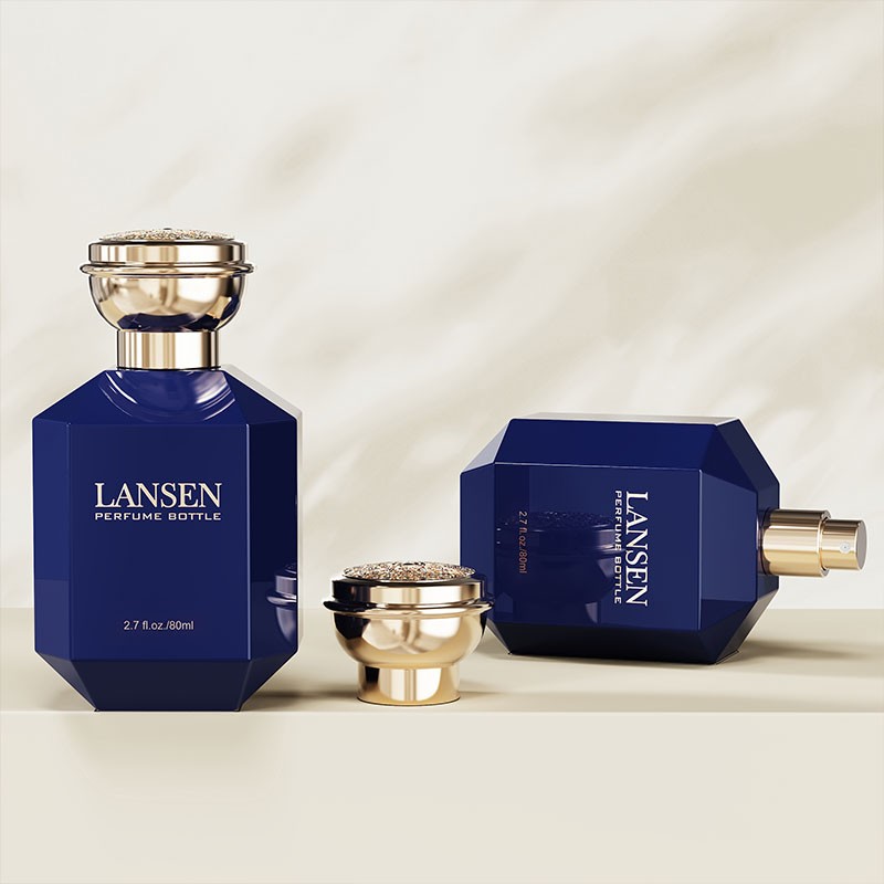 80ml octagonal perfume bottle in navy blue with a gold cap, shown upright and lying on its side with a gold sprayer