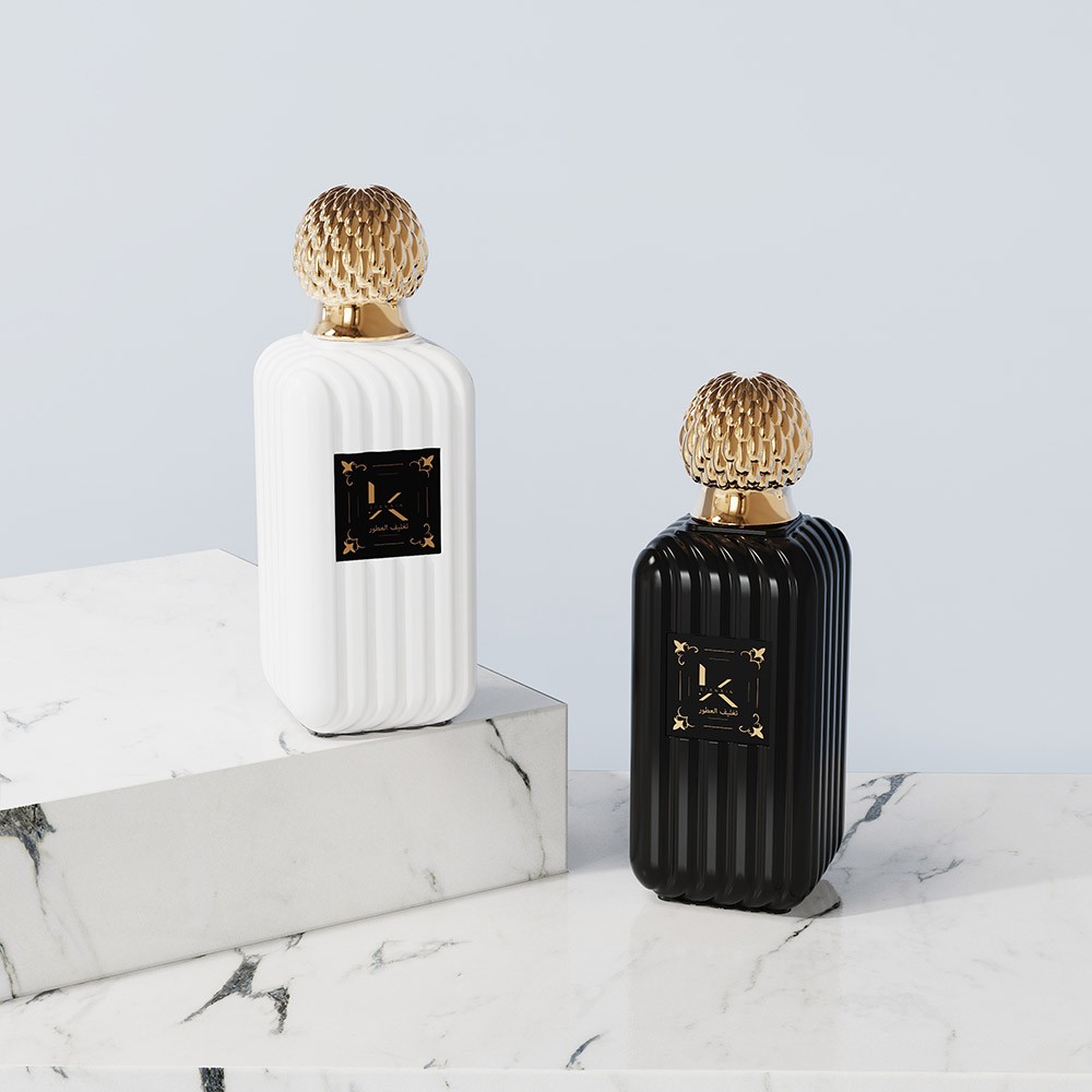 ribbed rectangular glass perfume bottles in opaque white and glossy black with gold fluted caps and printed front labels