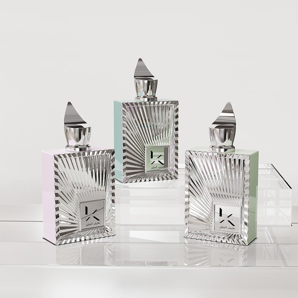 silver and clear rectangular perfume bottles with sunburst ray relief and pointed metal caps in pastel colour options