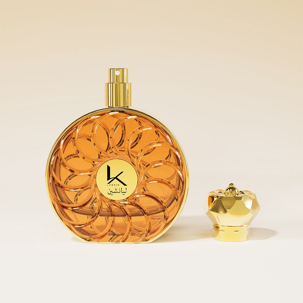 round spiral pattern perfume bottle in amber with the gold sprayer exposed and the faceted cap beside it
