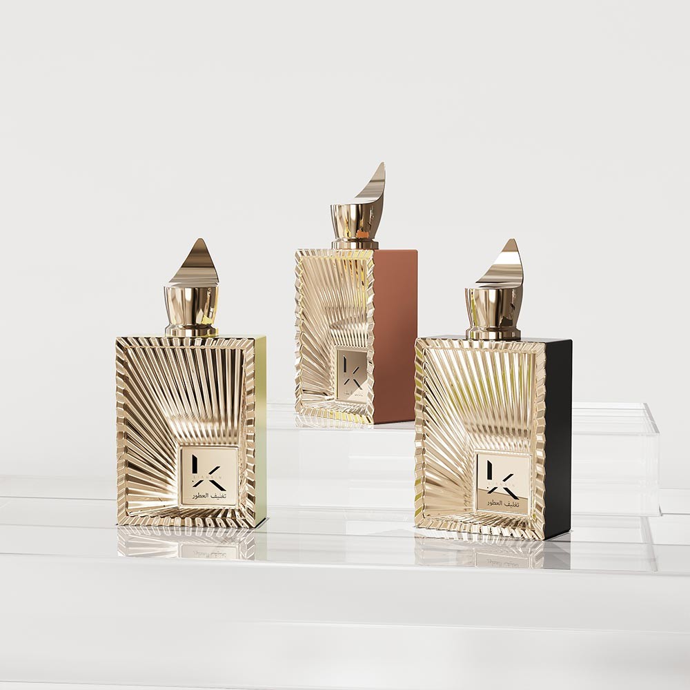 stepped edge gold and champagne rectangular perfume bottles with sunburst ray relief and pointed gold plastic caps